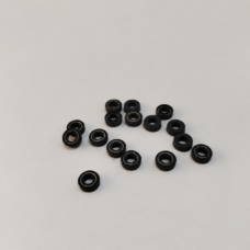 Small black annular seals with visible metal spring elements.