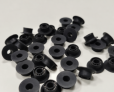 Black flanged seals, some showing metal spring elements around their central openings.