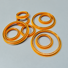 Yellow annular seals with exposed metal spring elements in several sizes.