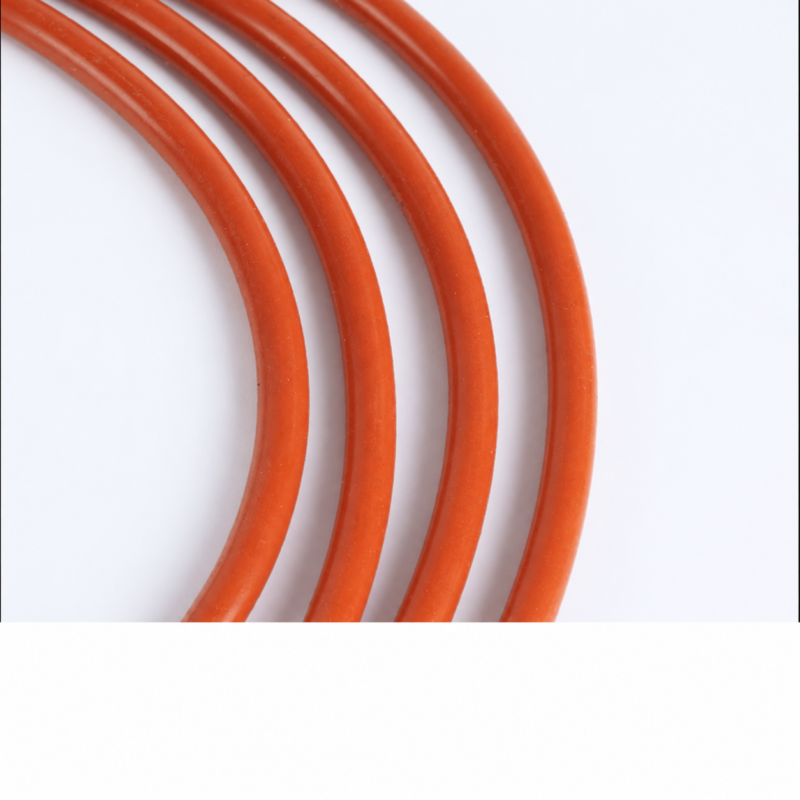 Close-up of four curved lengths of IKSONIC red solid silicone round cord.
