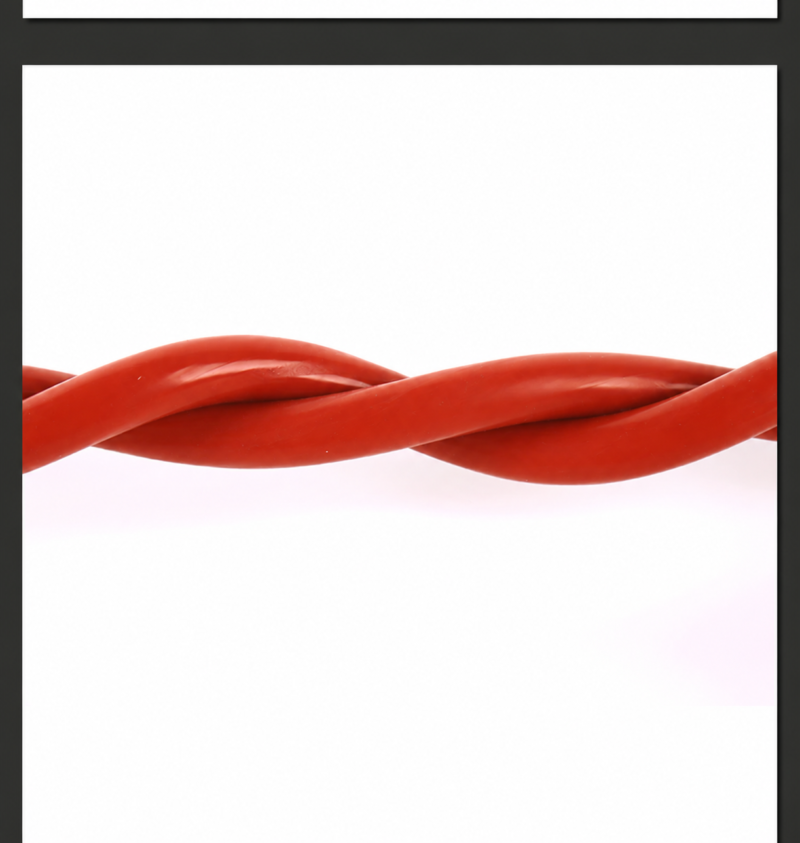 Close-up of intertwined lengths of IKSONIC red solid silicone round cord.