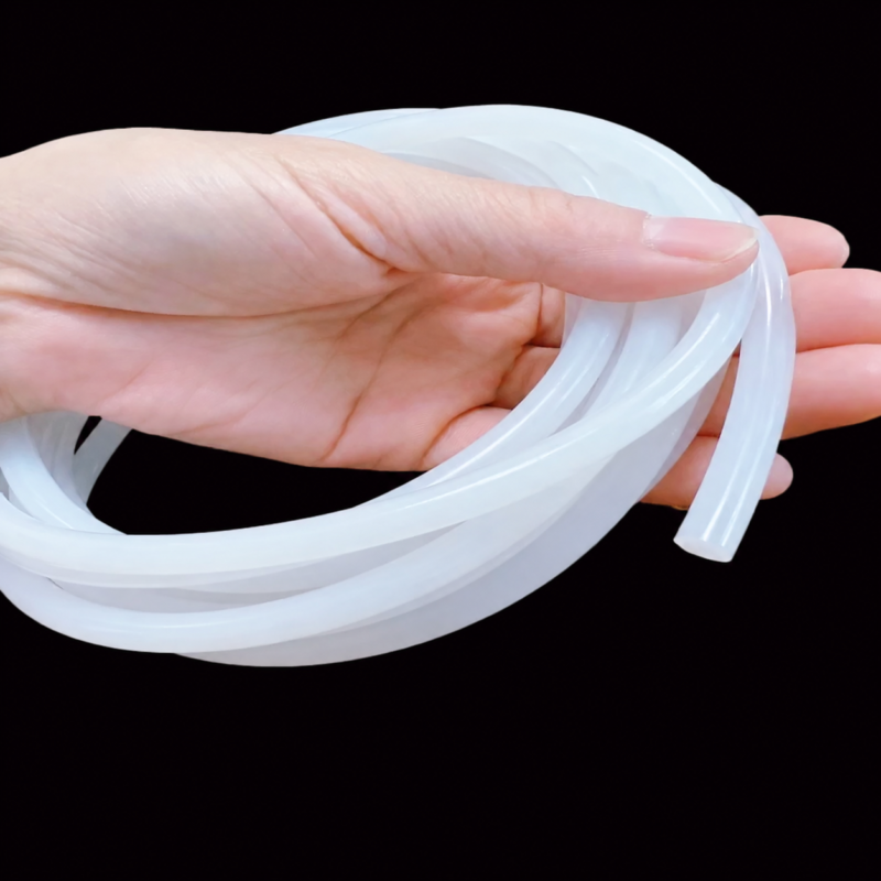 A hand holding a coil of translucent white solid silicone sealing cord against a black background; IKSONIC China supplier product view.