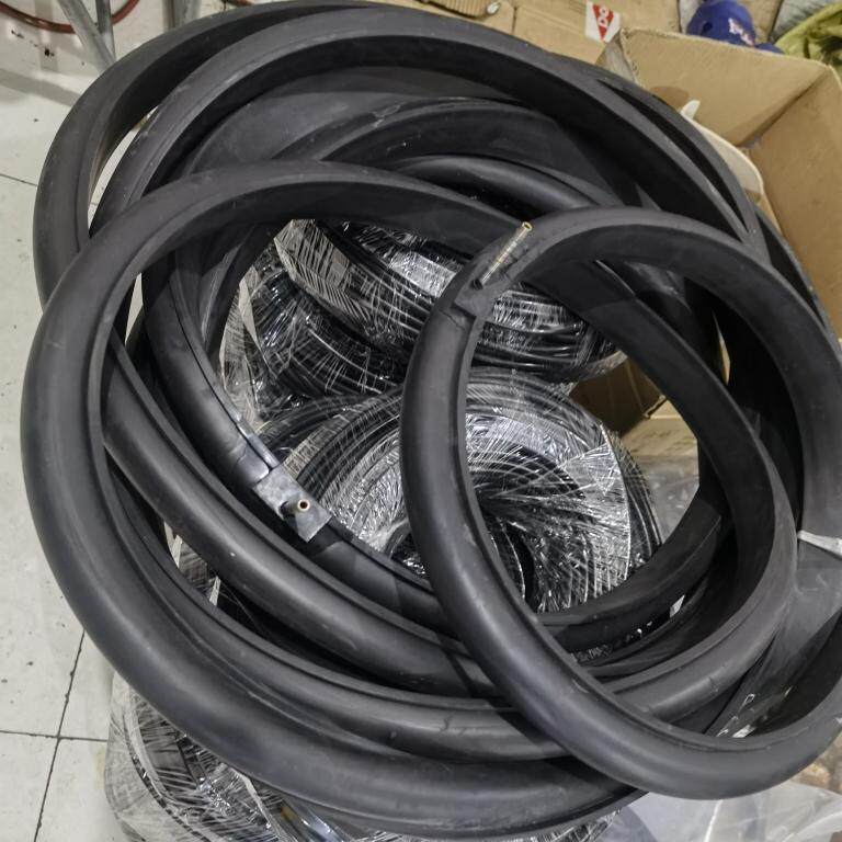 Black annular inflatable seals with metal inflation stems, stacked in several sizes.