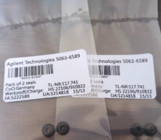 Four small black annular seals in two clear packages with original English product labels.