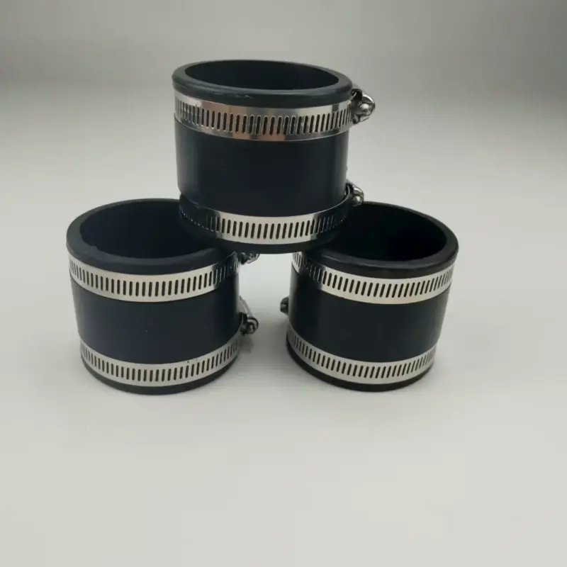 clamp-style-pipe-connectors-extended-size-selection-361-hero Three black straight pipe connectors with metal hose clamps arranged in a pyramid.