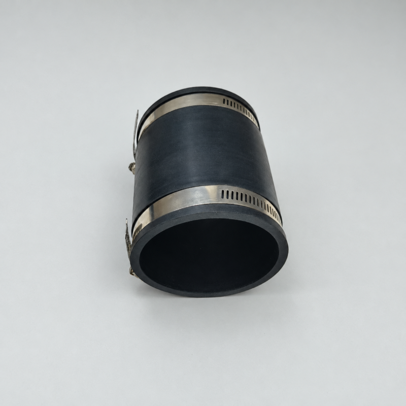 Reverse-angle view of a black straight pipe connector showing its open bore and two metal hose clamps.