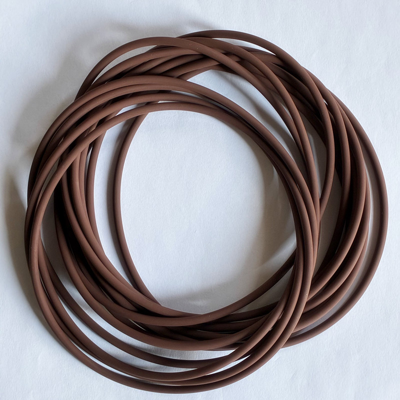 Brown round-section O-rings overlapping on a white surface.