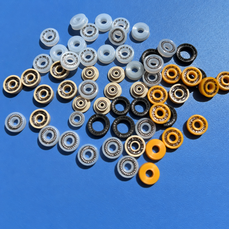 Dispensing valve spring-energized seals UPE and PEEK options Small dispensing valve spring-energized seals in white, beige, yellow and black with visible springs.
