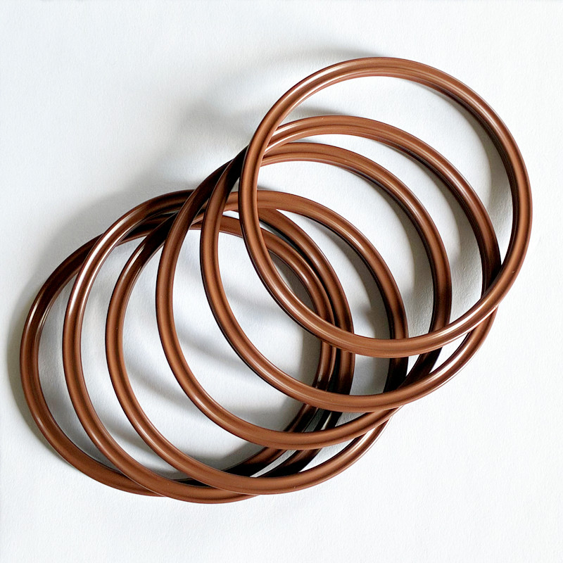 Several brown sealing rings overlapping to show their circular grooved profiles.