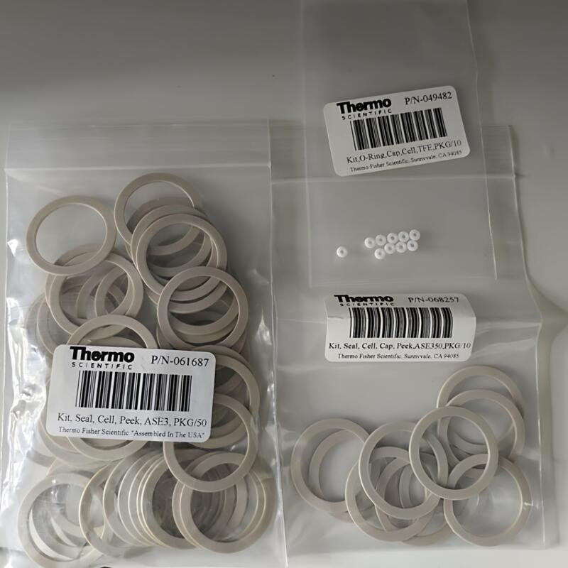 Flat grey-beige annular gaskets in clear bags beside original English product labels.