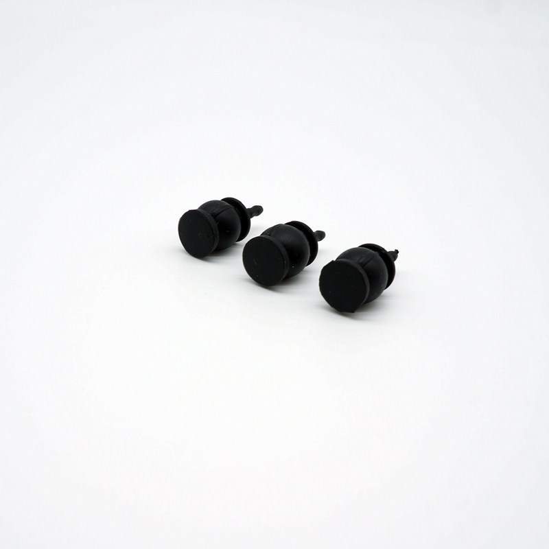 Three black gimbal damping balls resting on their sides, showing flat mounting bases