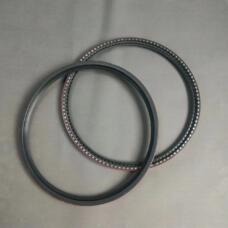 Two large shaft sealing rings showing smooth sealing faces and exposed segmented inner edges