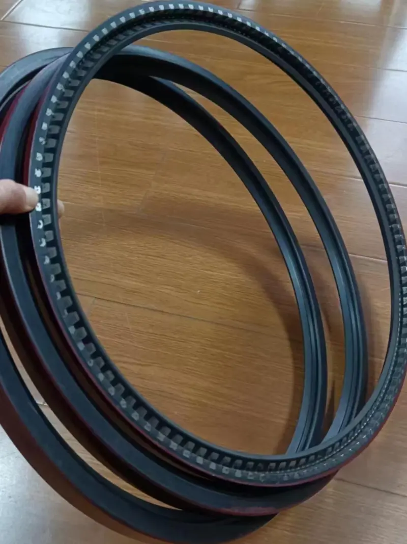 Fluororubber grinding roller shaft seals Large dark grinding roller shaft seals held over a wood-patterned floor