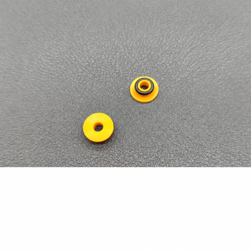 Supplier photograph of two yellow chromatography pump seals in opposite orientations, one with a black ring.
