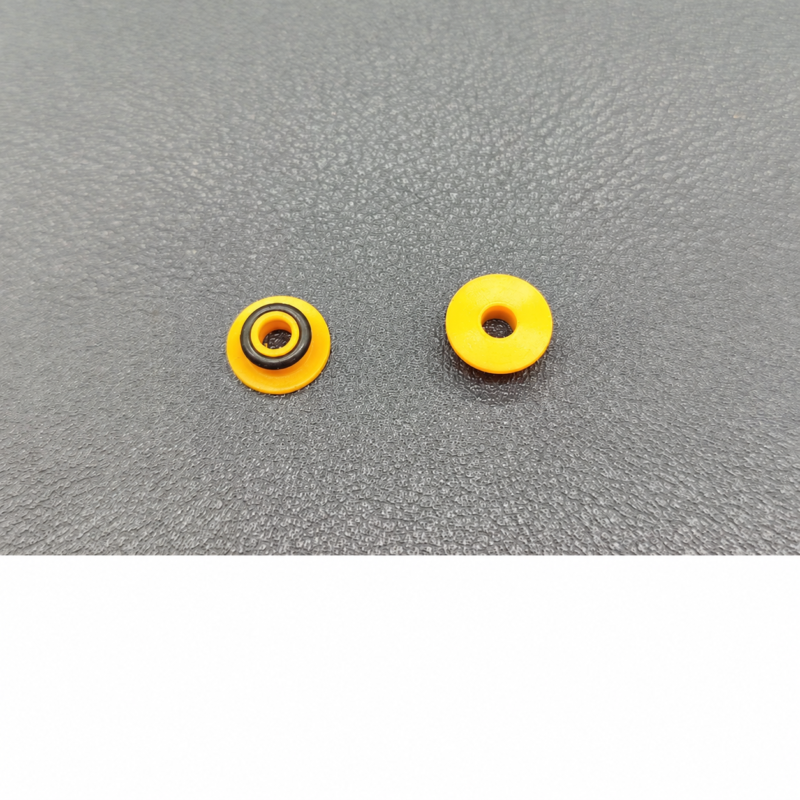 Supplier photograph of two yellow chromatography pump seals viewed side by side, one with a black ring.