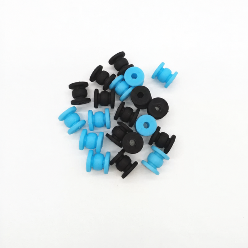 Assorted black and blue 12 mm silicone drone gimbal vibration dampers on a white surface – IKSONIC China supplier.