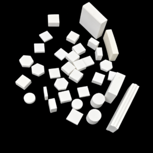 Assorted white IKSONIC ceramic plates, tiles and profiles arranged on a black background.