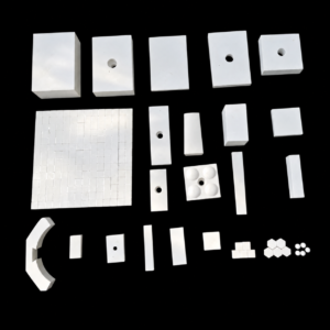 Assortment of white IKSONIC ceramic liner shapes, including drilled plates, strips, curved pieces and mosaic tiles.