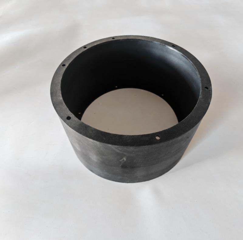 iksonic-black-cylindrical-sealing-ring-rim-holes Black IKSONIC cylindrical inflatable rubber seal with a flanged rim and visible mounting holes on a light background.