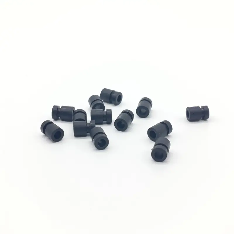Black cylindrical damping parts with visible end bores and retention grooves, IKSONIC supplier