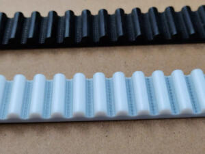 Black and white IKSONIC timing belt samples showing rounded tooth profiles and visible cord lines.