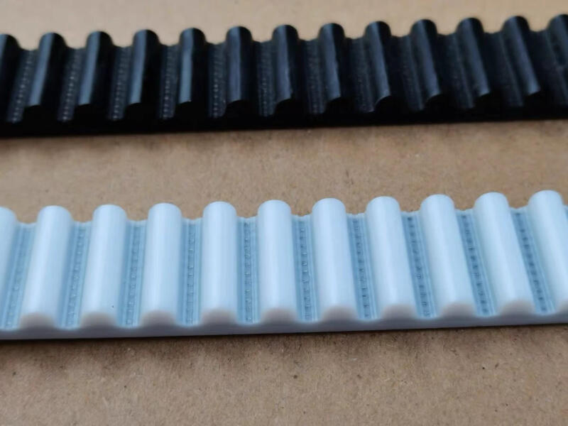 Black and white IKSONIC timing belt samples showing rounded tooth profiles and visible cord lines.