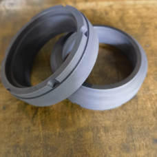 C8B-series antimony-impregnated graphite rotating seal rings with stepped faces and drive notches.