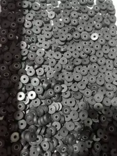 A pile of small dark flanged seals, many with visible internal springs; supplied by IKSONIC in China.