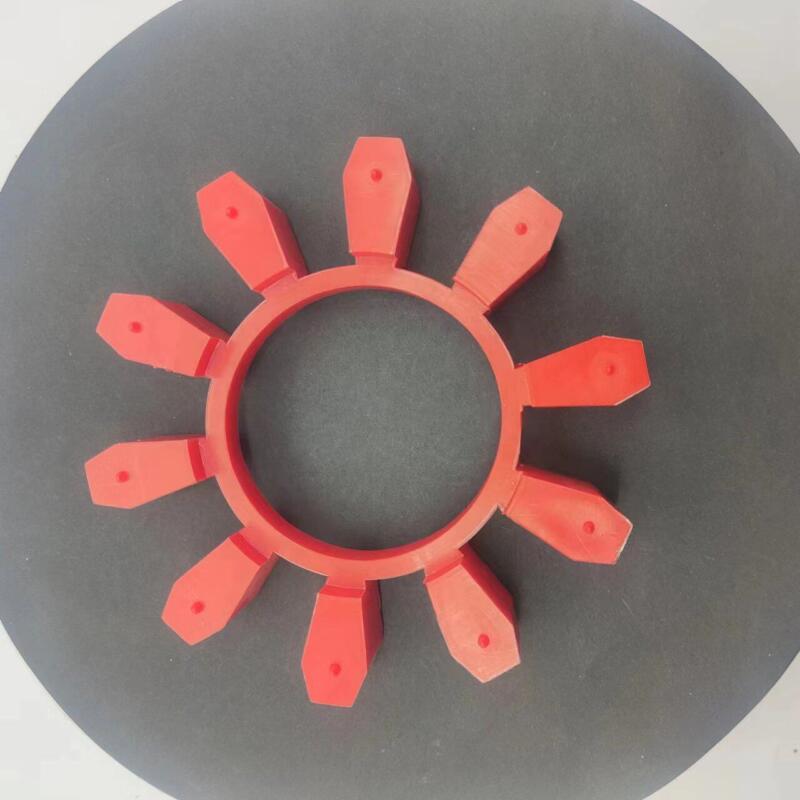 Top view of a red ten-lobe coupling insert on a dark circular surface; supplied by IKSONIC in China.