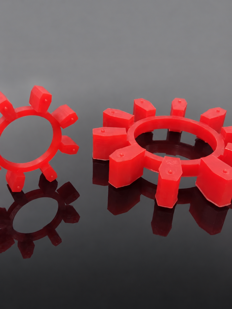 IKSONIC BWN coupling inserts - China supplier Red coupling inserts with rectangular radial lobes on a dark reflective surface; supplied by IKSONIC in China.
