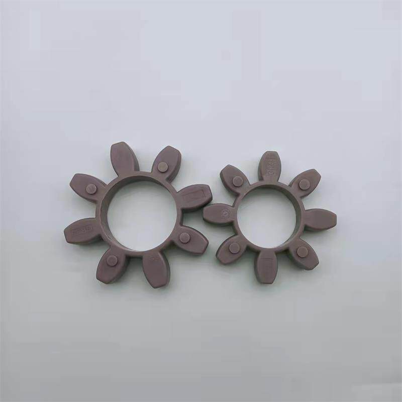 IKSONIC GR star coupling inserts - China supplier Two purple-brown star coupling inserts with central openings and eight radial lobes; supplied by IKSONIC, China.