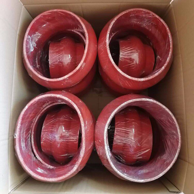 Red flexible pipe connectors wrapped in clear film and packed in a cardboard box; supplied by IKSONIC in China.