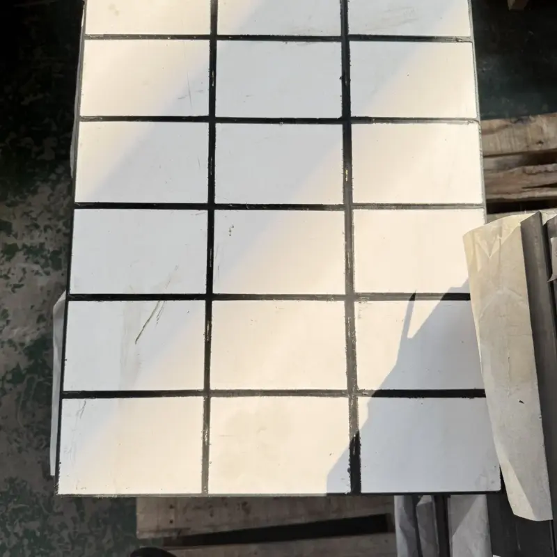 White square ceramic tiles arranged in a dark grid on an IKSONIC composite liner panel.