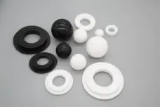 Black and white diaphragm pump balls and stepped seats in assorted sizes, supplied by IKSONIC in China