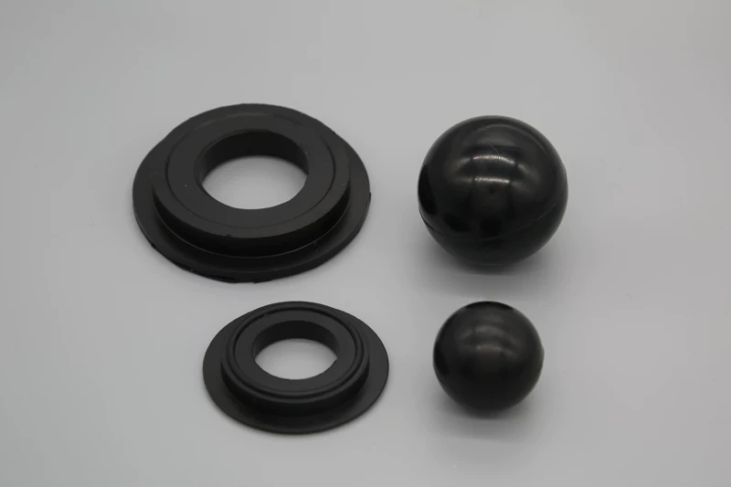 Two black pump balls with stepped ring seats shown in different sizes, IKSONIC supplier product detail