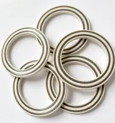 Overlapping PEEK seals showing dual spring channels and sidewall thickness, IKSONIC wholesale product view.