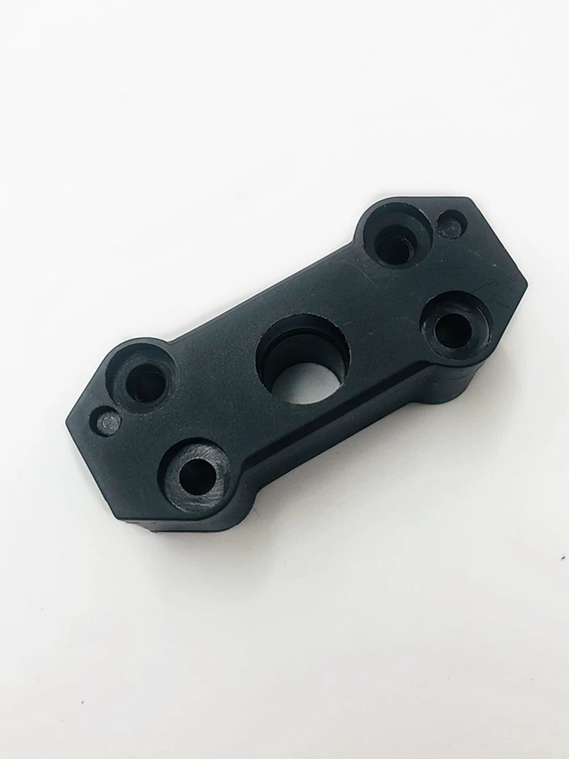 Close view of the black door belt clamp face showing its central opening and four mounting holes, supplied by IKSONIC.