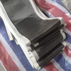 Folded IKSONIC fabric expansion joint skins with black surfaces and white edges.