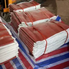 Bundled fabric expansion joint skins with red surfaces and white edges.