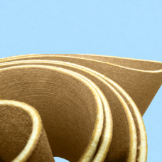 Close-up of IKSONIC felt conveyor belt layers and pale cut edges.