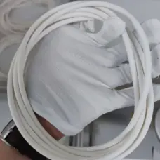 White FFKM O-rings held in a gloved hand, IKSONIC supplier product detail.
