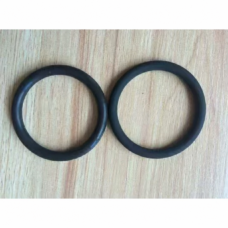 Two black FFKM O-rings side by side on a light wood surface, IKSONIC sealing product example.