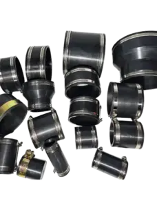 Assortment of black straight and reducing rubber pipe couplings with metal clamps.
