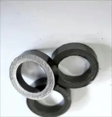 Three graphite valve sealing rings on a white background, from China supplier IKSONIC.