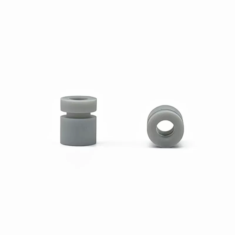 Side and end views of grey cylindrical damping parts showing the groove and central opening, from IKSONIC supplier.