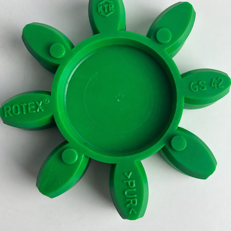 Close-up detail of a green coupling spider showing its recessed center, molded GS 42 marking and round bosses; the upper arm is cropped; supplied by IKSONIC in China.