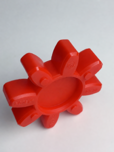 Supplier image of a red eight-arm coupling spider standing at an angle, with a recessed circular center and molded markings; supplied by IKSONIC in China.