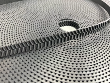 Black herringbone-tooth belt across a coiled length, supplied by IKSONIC in China.