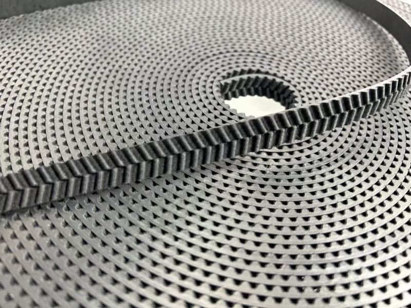 Black herringbone-tooth belt across a coiled length, supplied by IKSONIC in China.