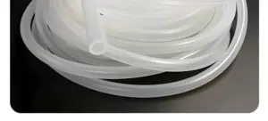 Close-up of translucent IKSONIC industrial silicone tubing coils and an open end.